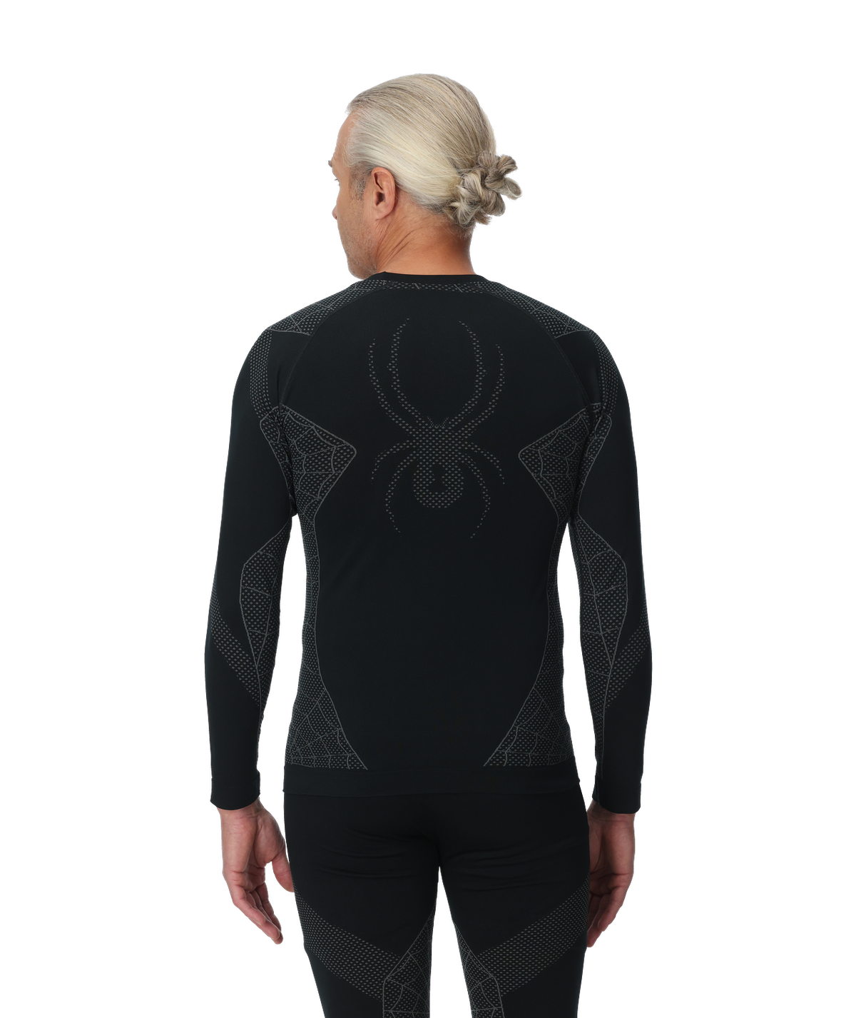 Person wearing a black compression garment with a spider logo on the back, on a white background
