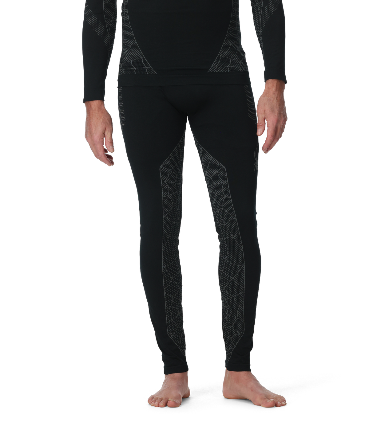 Person wearing black thermal leggings with geometric patterns on a white background