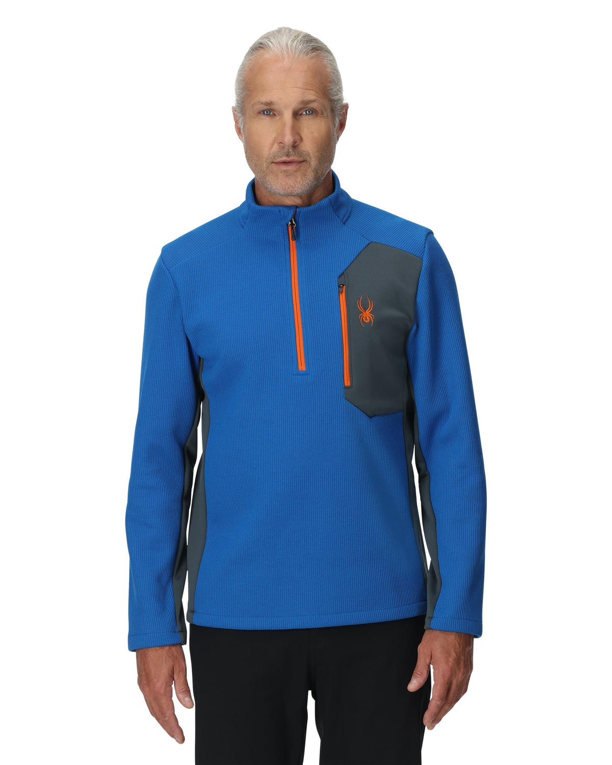 Man wearing a blue pullover with orange accents on a white background