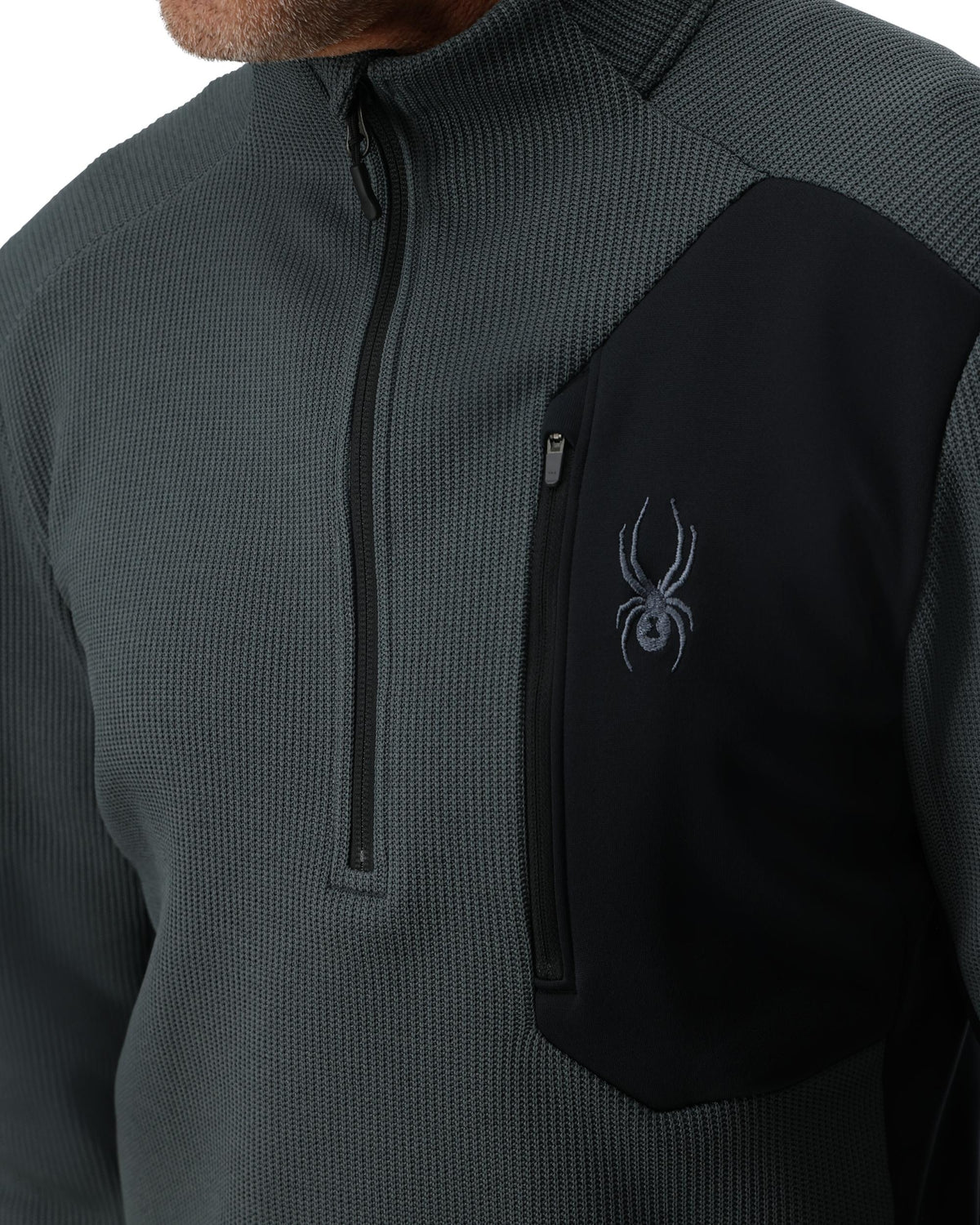 Gray and black jacket with a logo on the chest against a white background