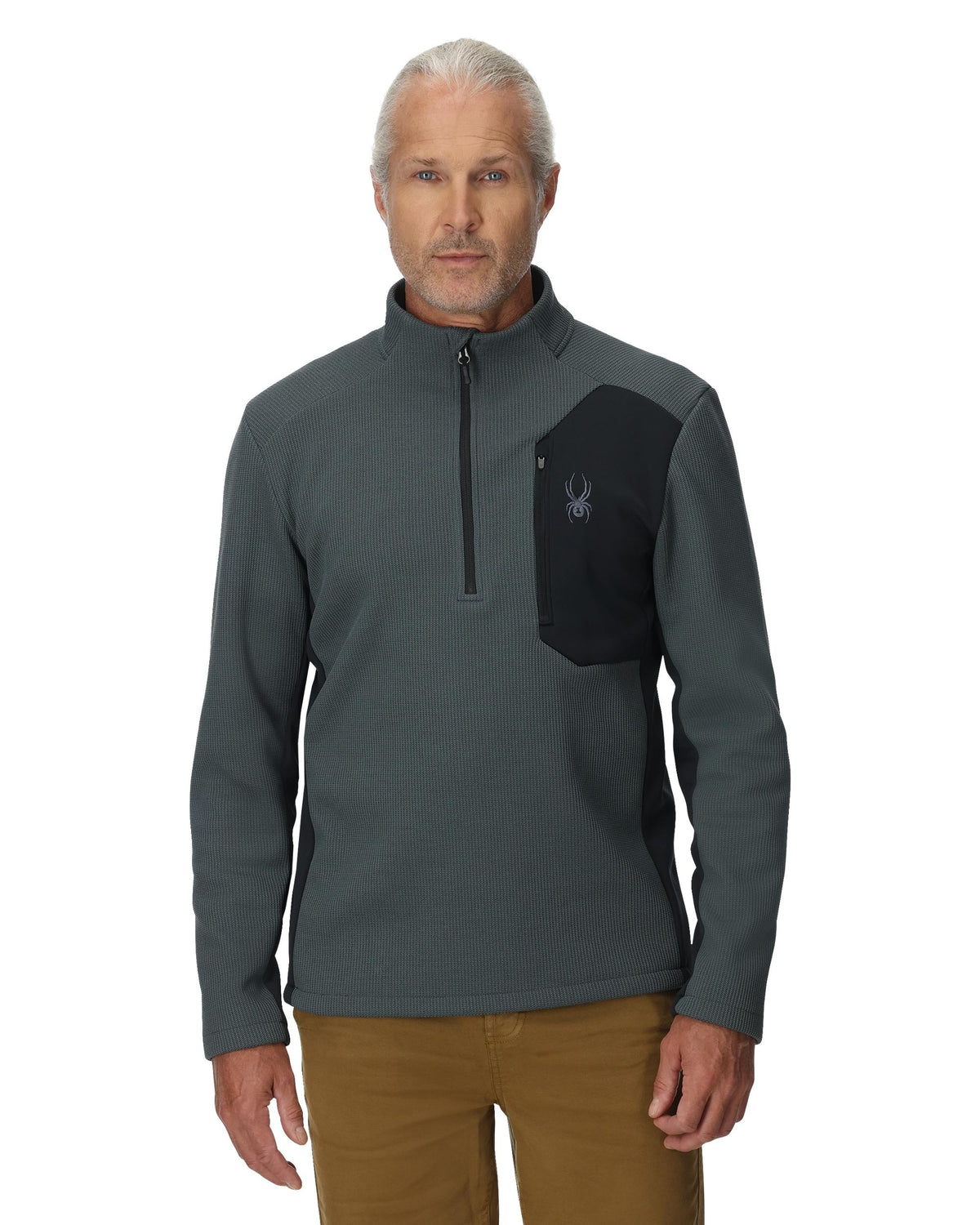 Man wearing a gray and black pullover with a logo on a white background