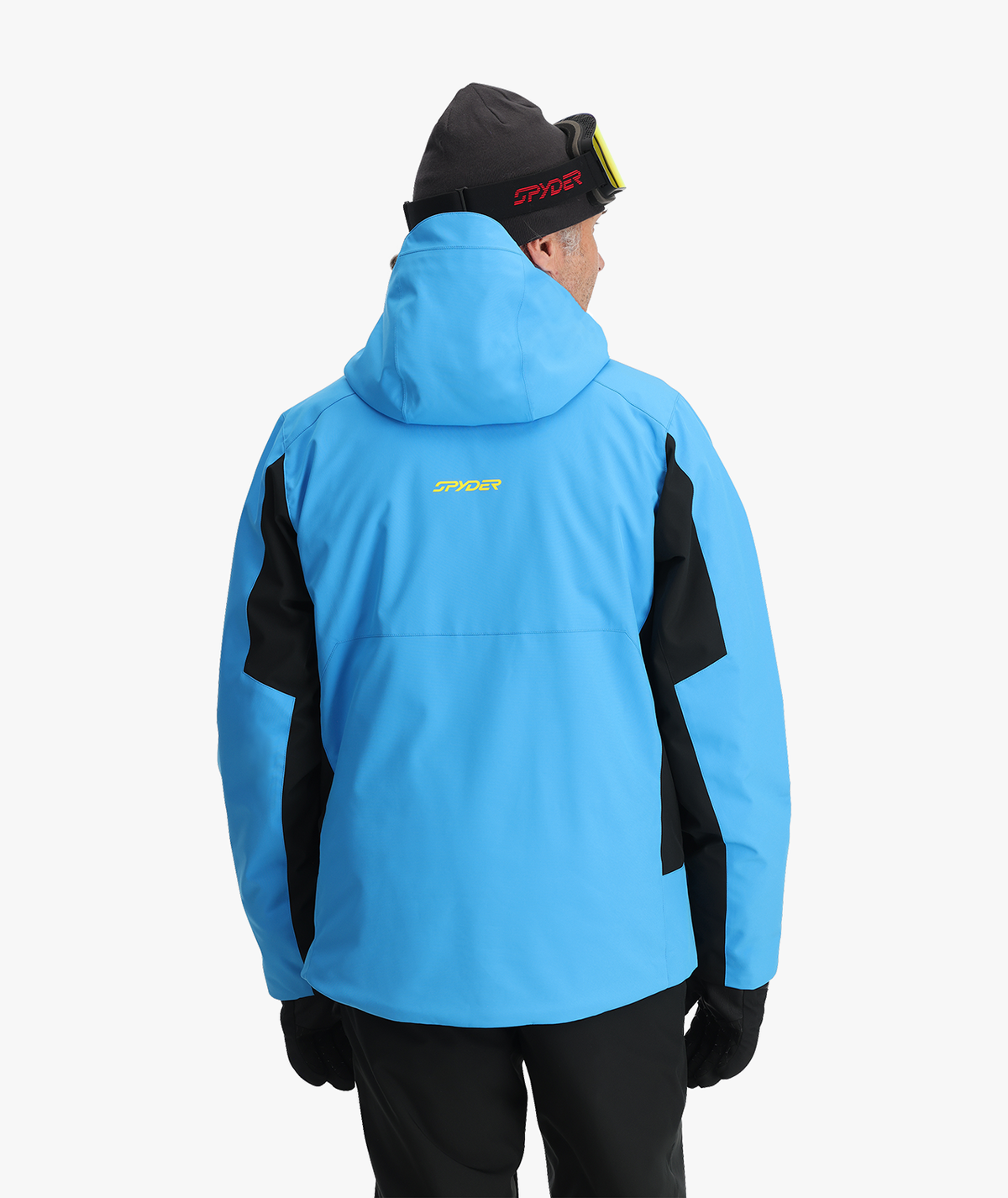 Person wearing a blue and black jacket with a visible brand logo on a white background