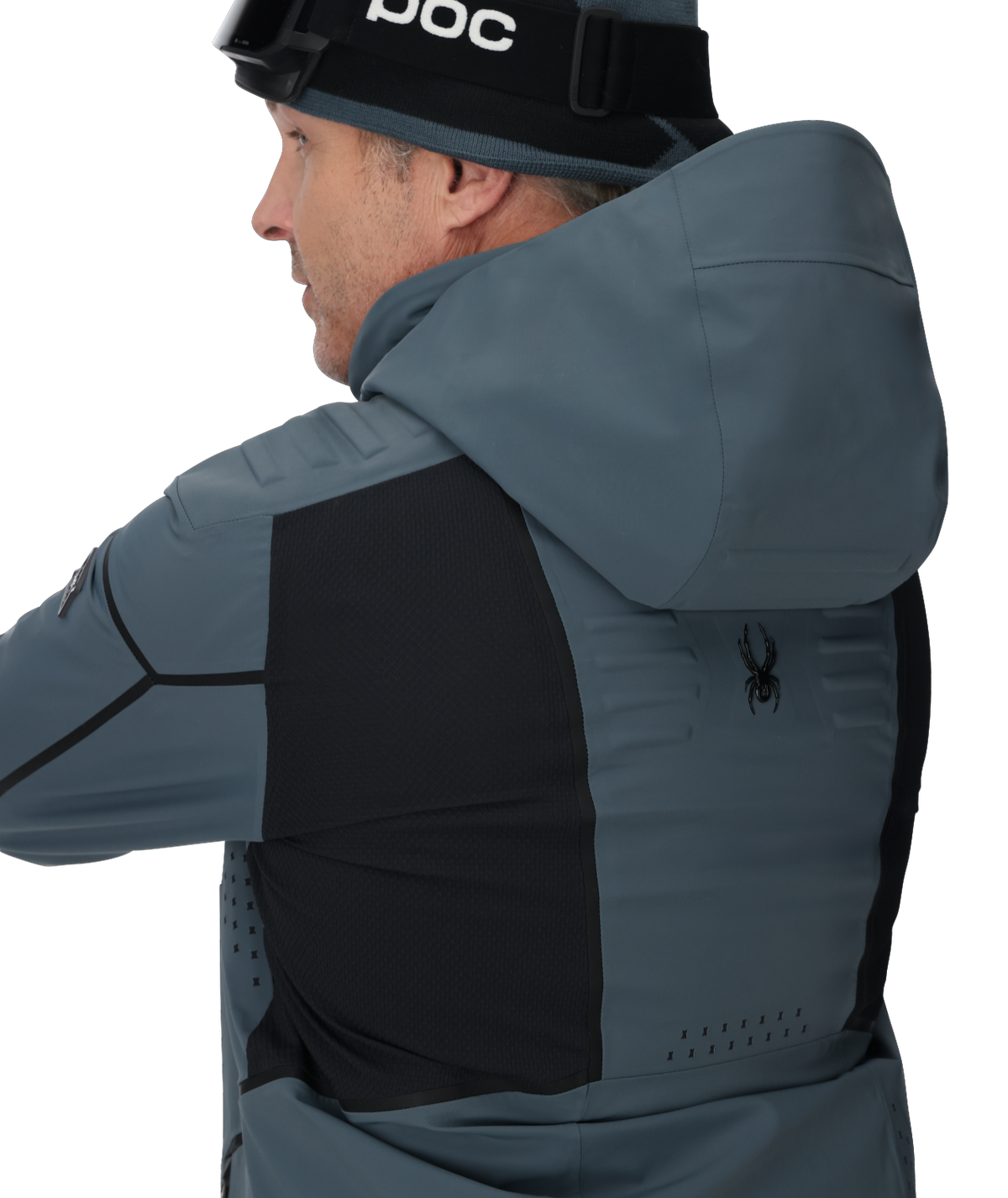 Person wearing a gray and black jacket with a hood, featuring a brand logo on the chest.