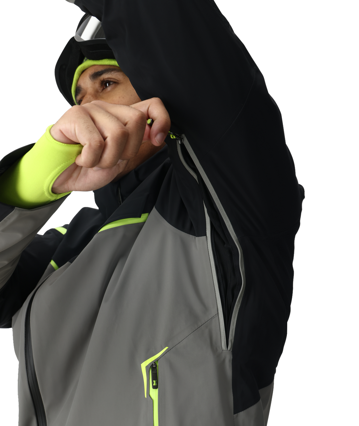 Person wearing a black, gray, and green jacket with a white background