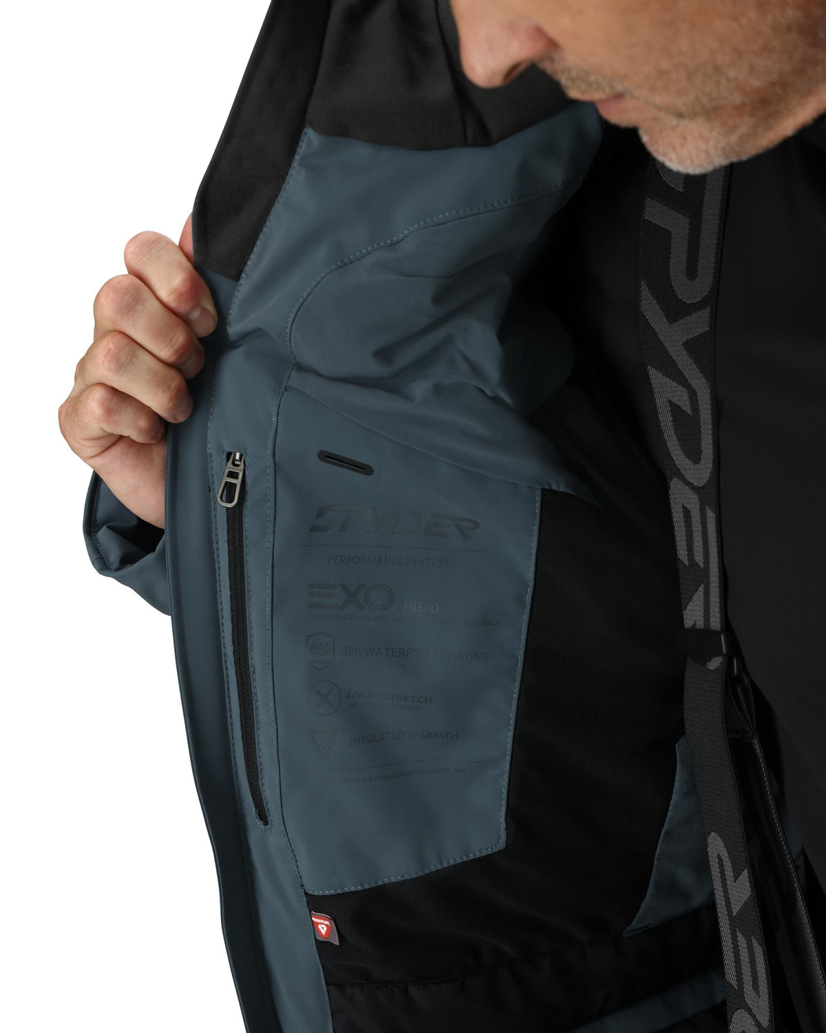 Person wearing a black and gray jacket with EXO branding
