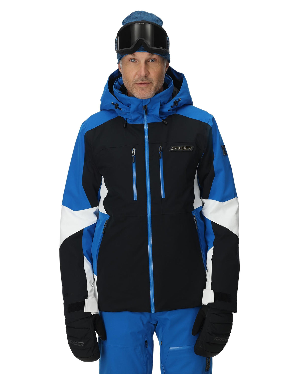Person wearing a black and blue ski jacket with white accents on a white background