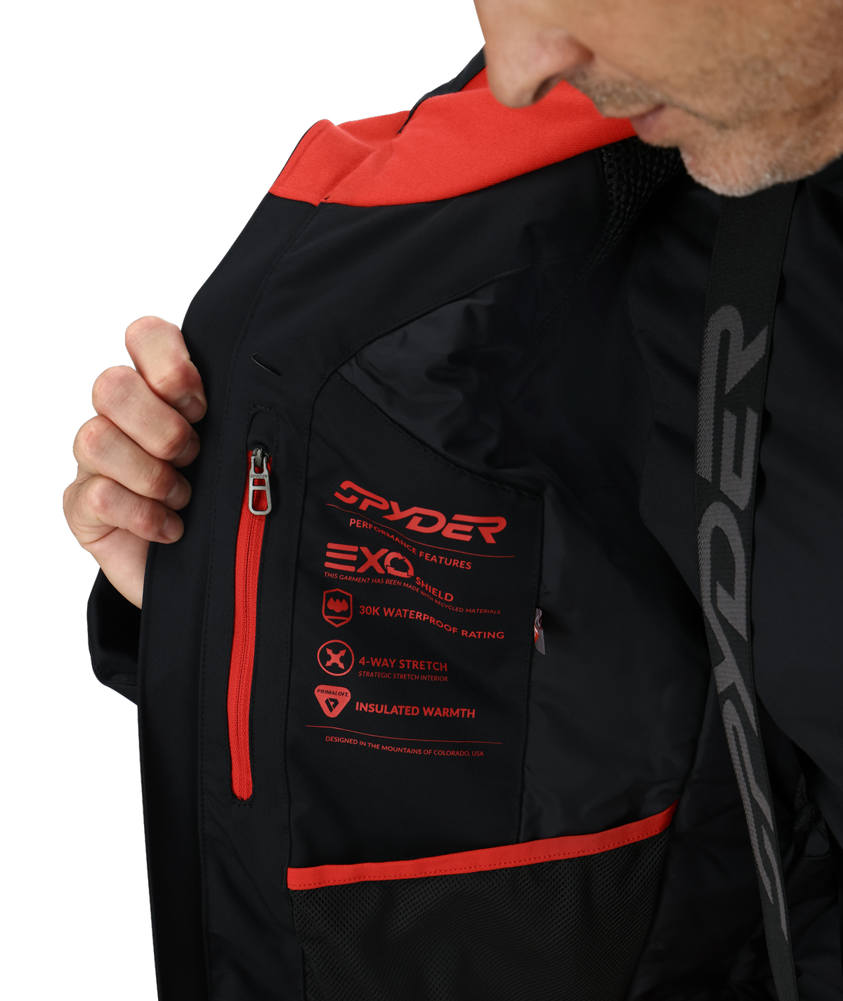 Black jacket with red accents and Spyder branding, featuring insulation and moisture-wicking text.