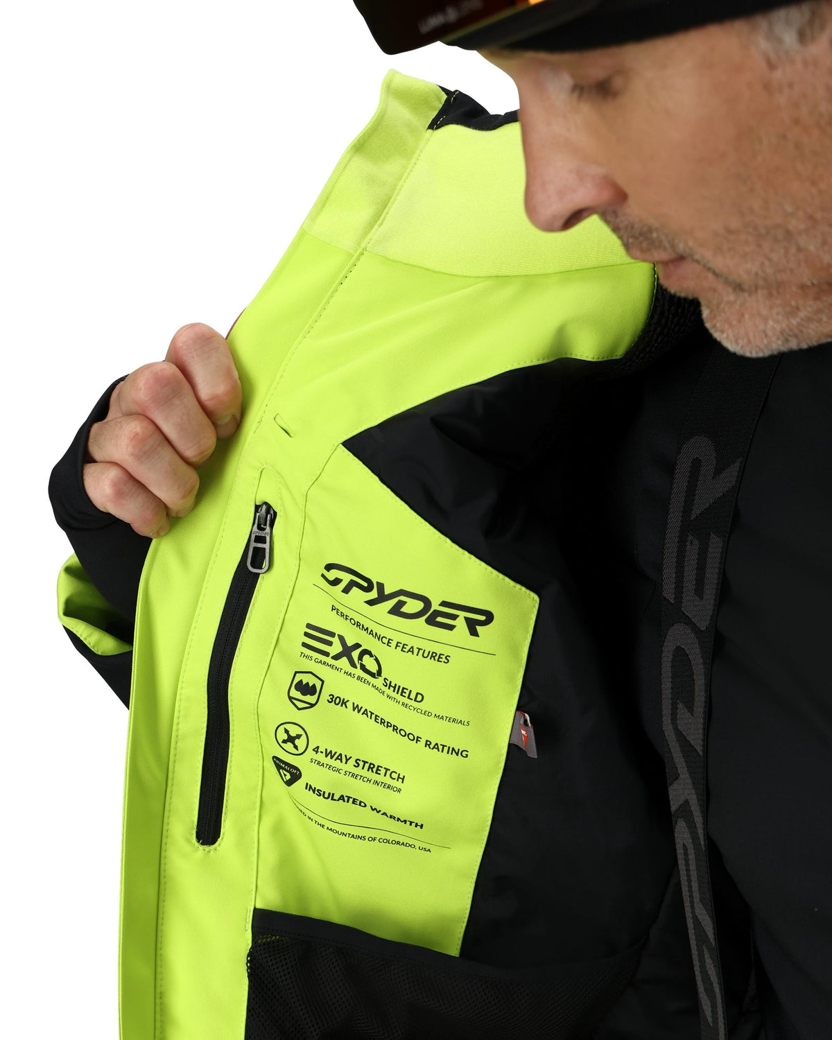 Person wearing a Spyder jacket with visible branding and features.