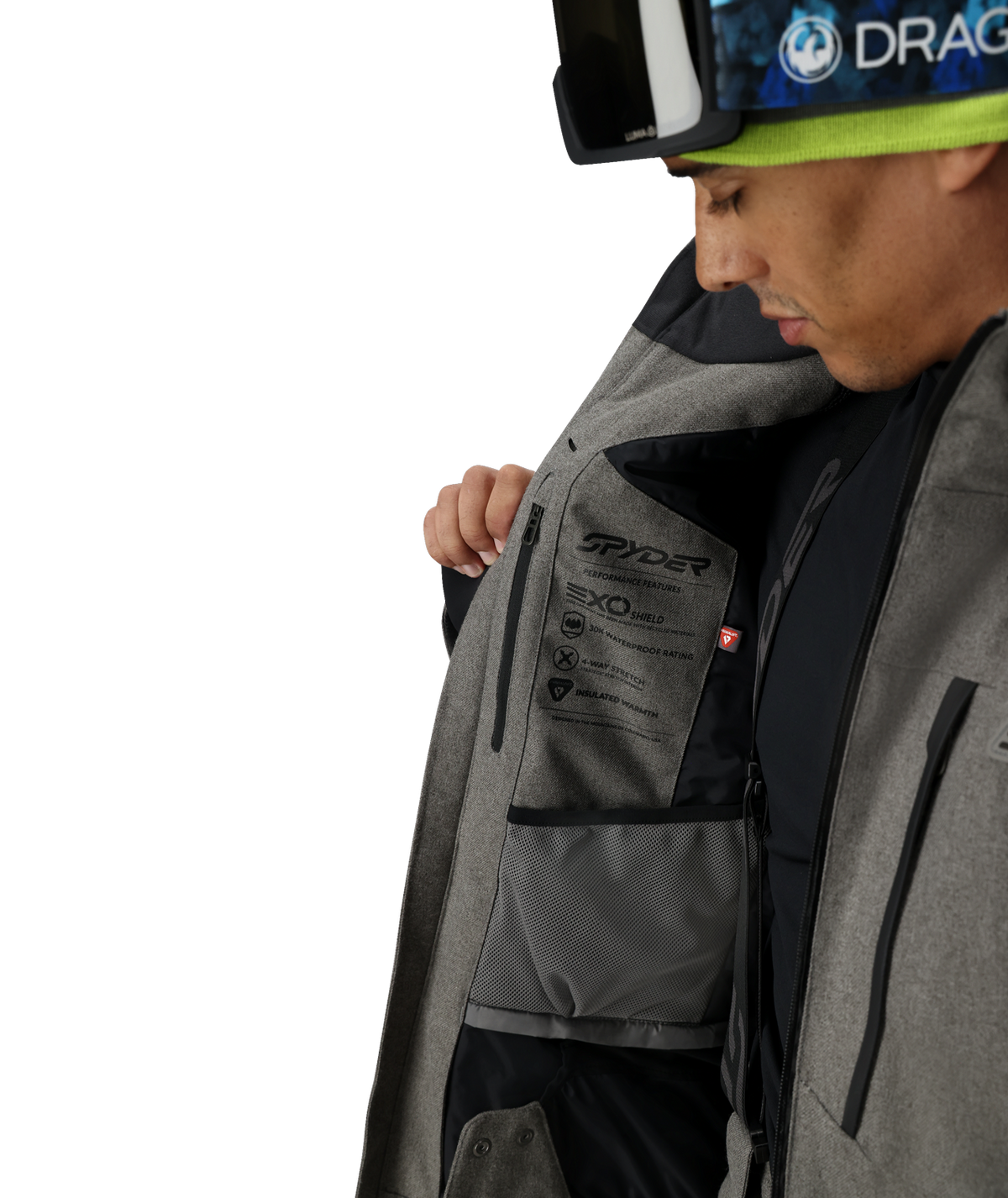 Person wearing a gray ski jacket with Spyder branding on a white background