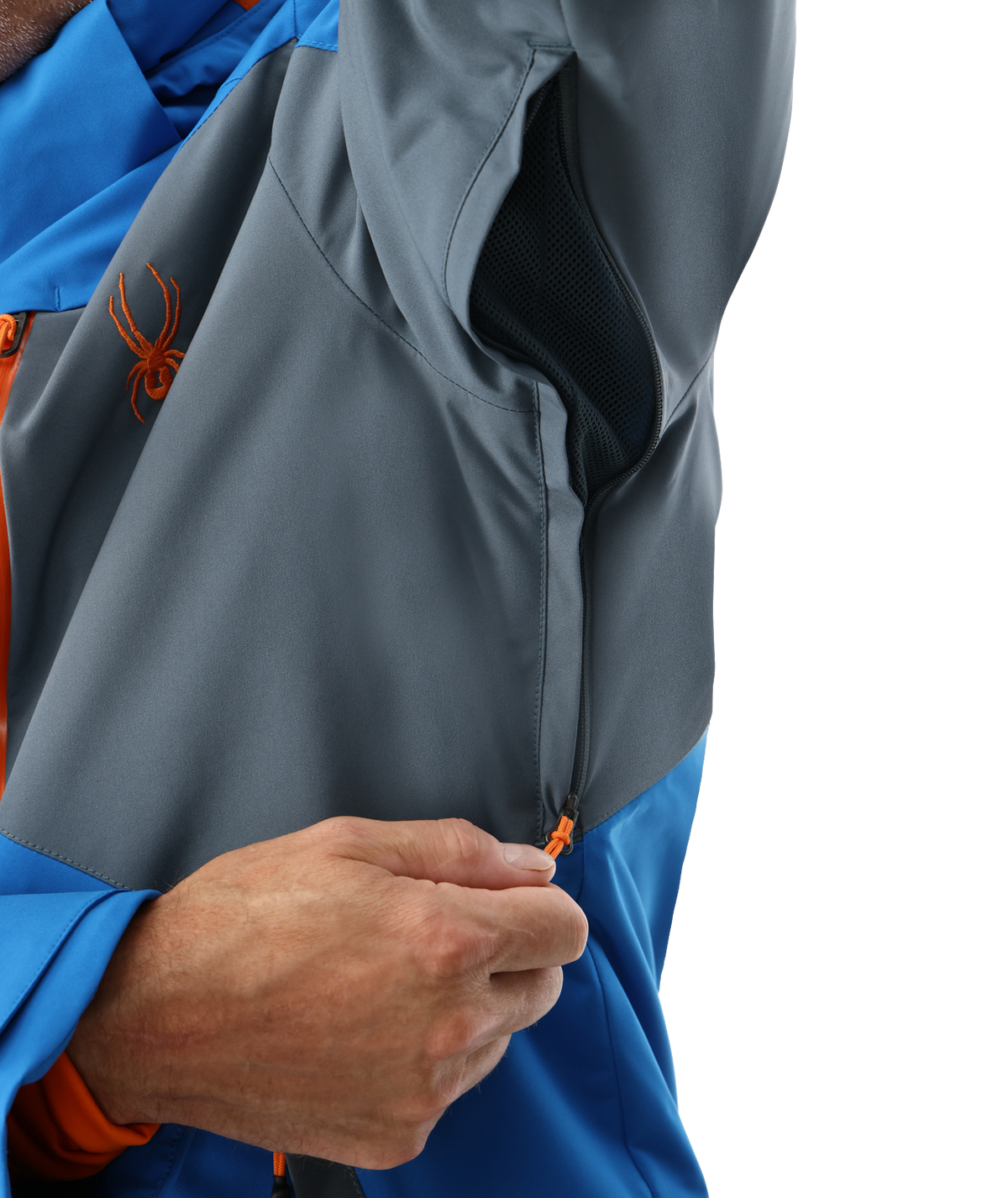 Close-up of a person wearing a gray and blue jacket with an orange zipper and logo.
