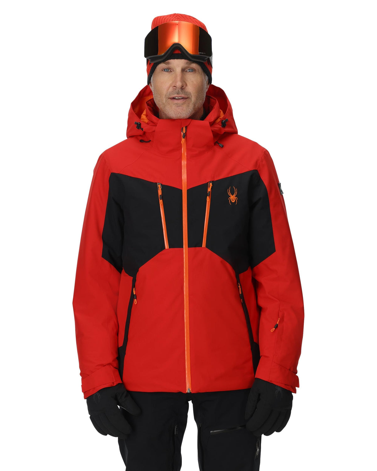 Person wearing a red and black ski jacket with a brand logo on a white background