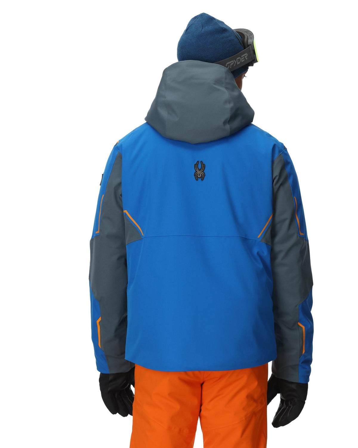 Person wearing a blue and gray jacket with orange pants on a white background
