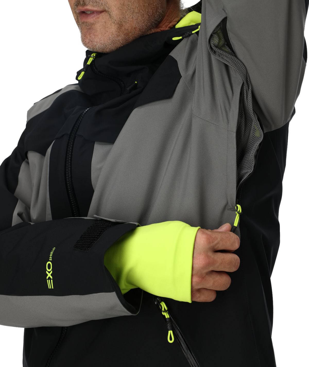 Close-up of a person wearing a gray and black jacket with neon yellow accents.