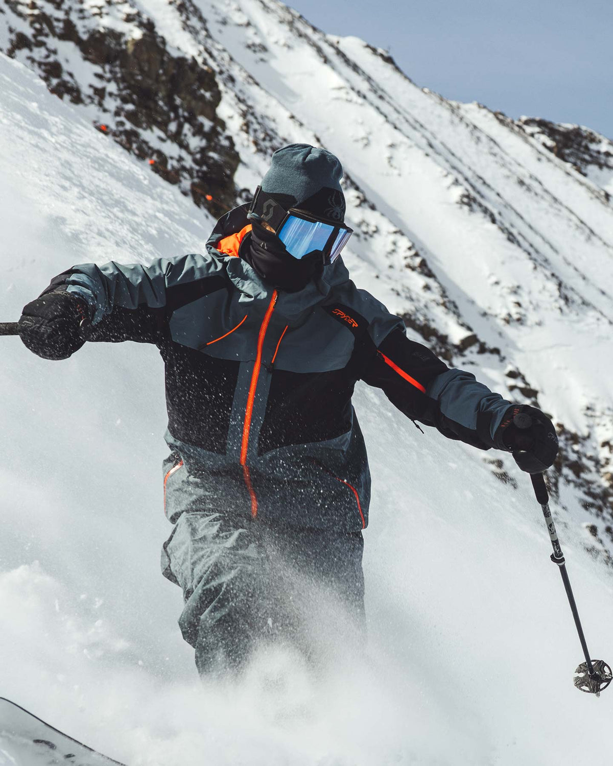 Person skiing down a snowy mountain with a helmet and goggles on