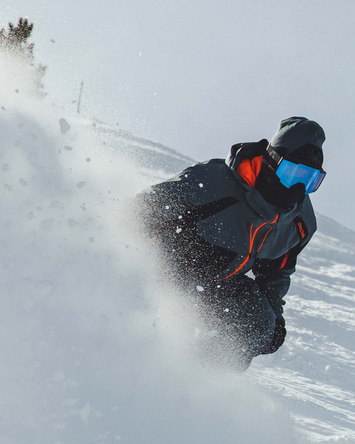 Person snowboarding in a snowy landscape with a focus on action and movement.