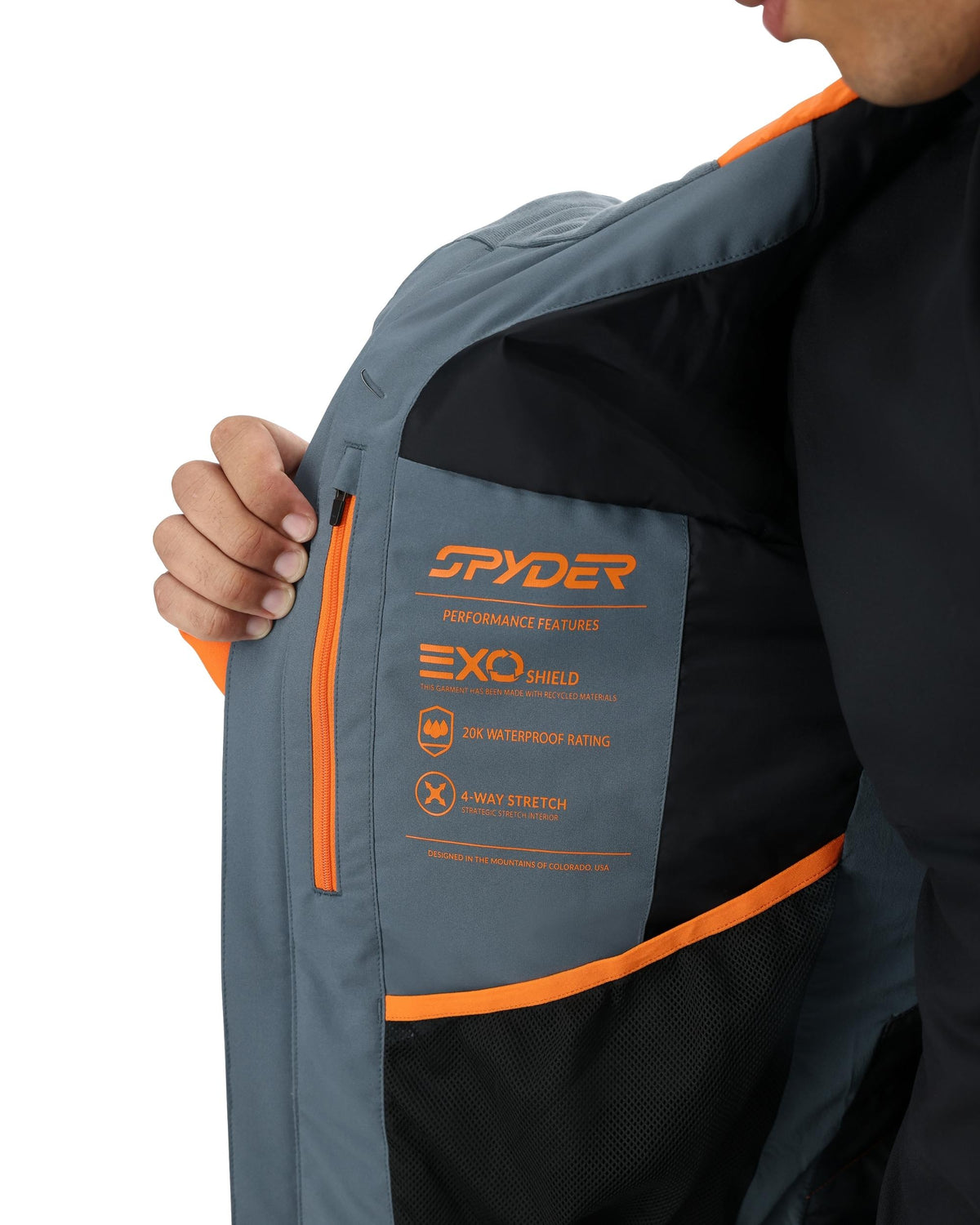 Close-up of a jacket with Spyder branding and features on a white background