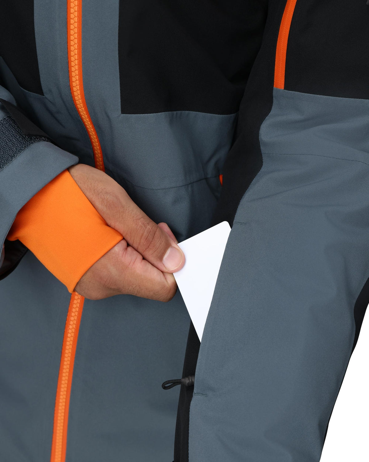 Close-up of a person wearing a gray jacket with orange accents on a white background