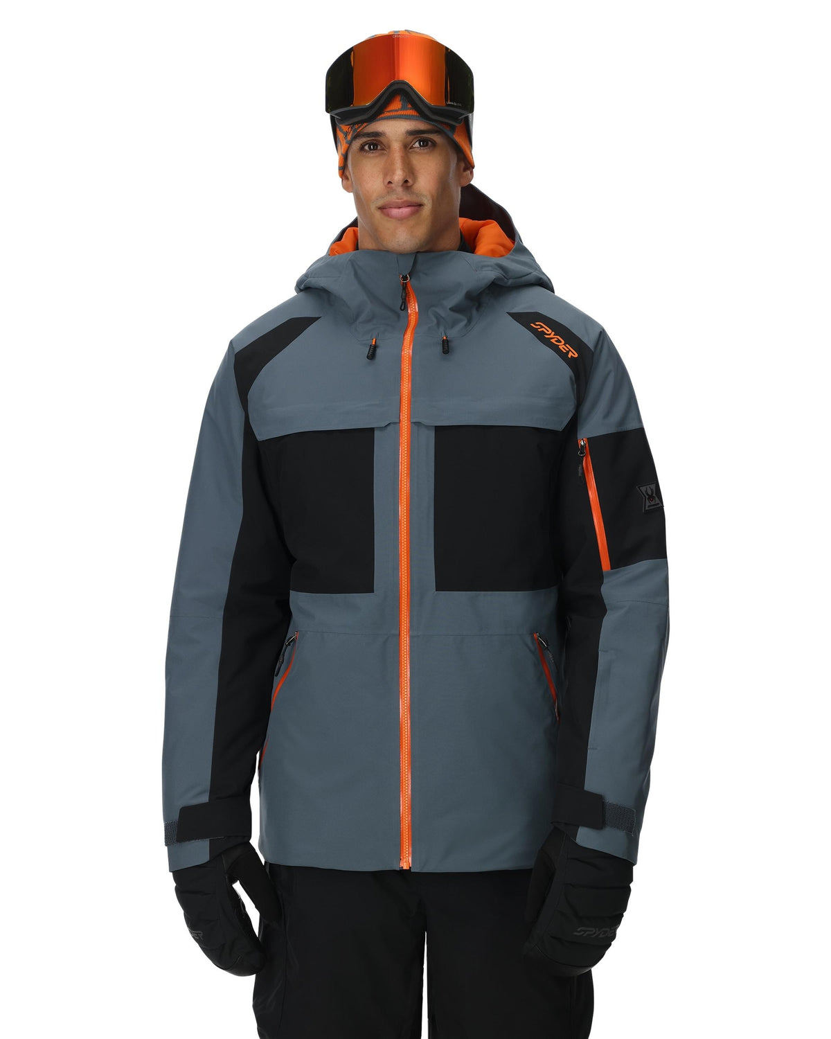 Person wearing a gray and black jacket with orange accents on a white background