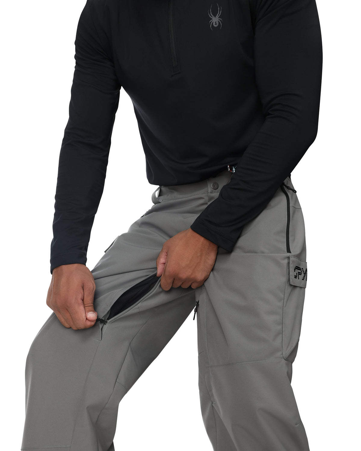 Person wearing a black long-sleeve shirt and gray pants on a white background