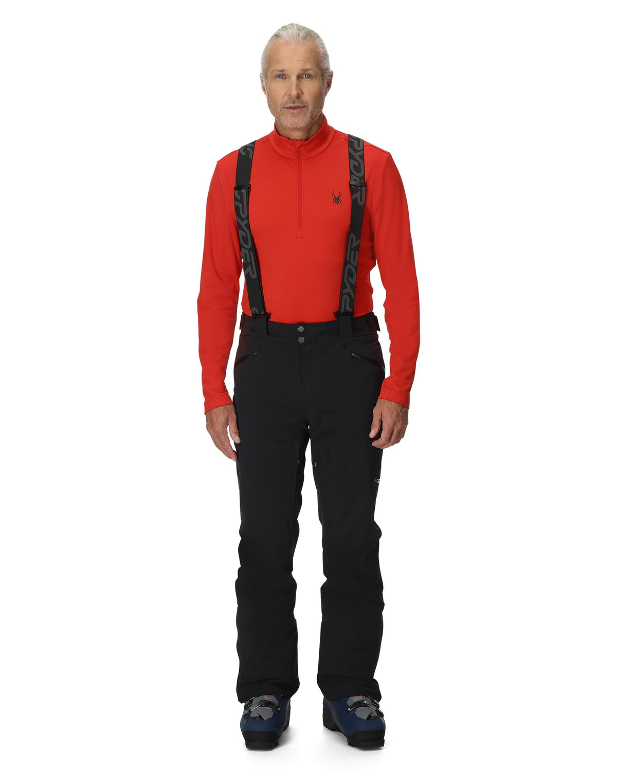Man wearing a red shirt, black pants, and suspenders on a white background