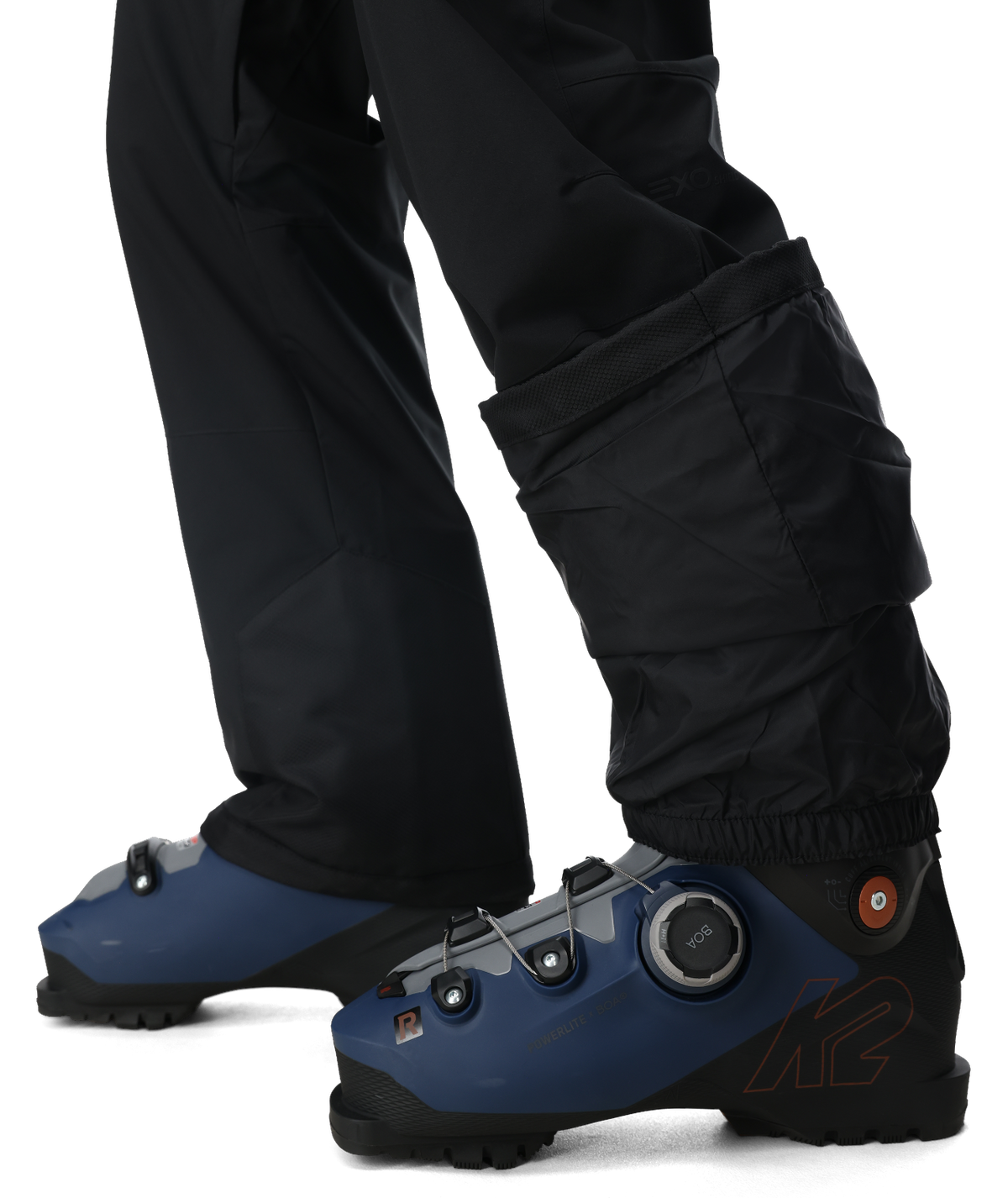 Blue ski boots with black pants on a white background