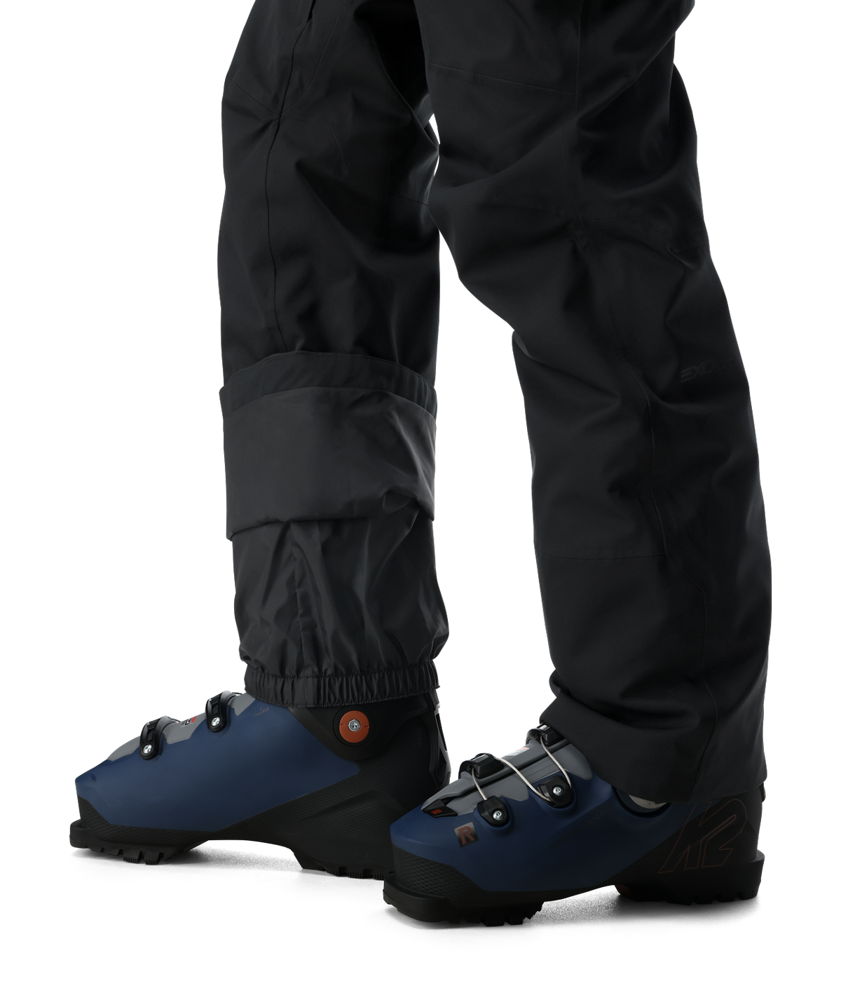 Blue ski boots with black pants on a white background