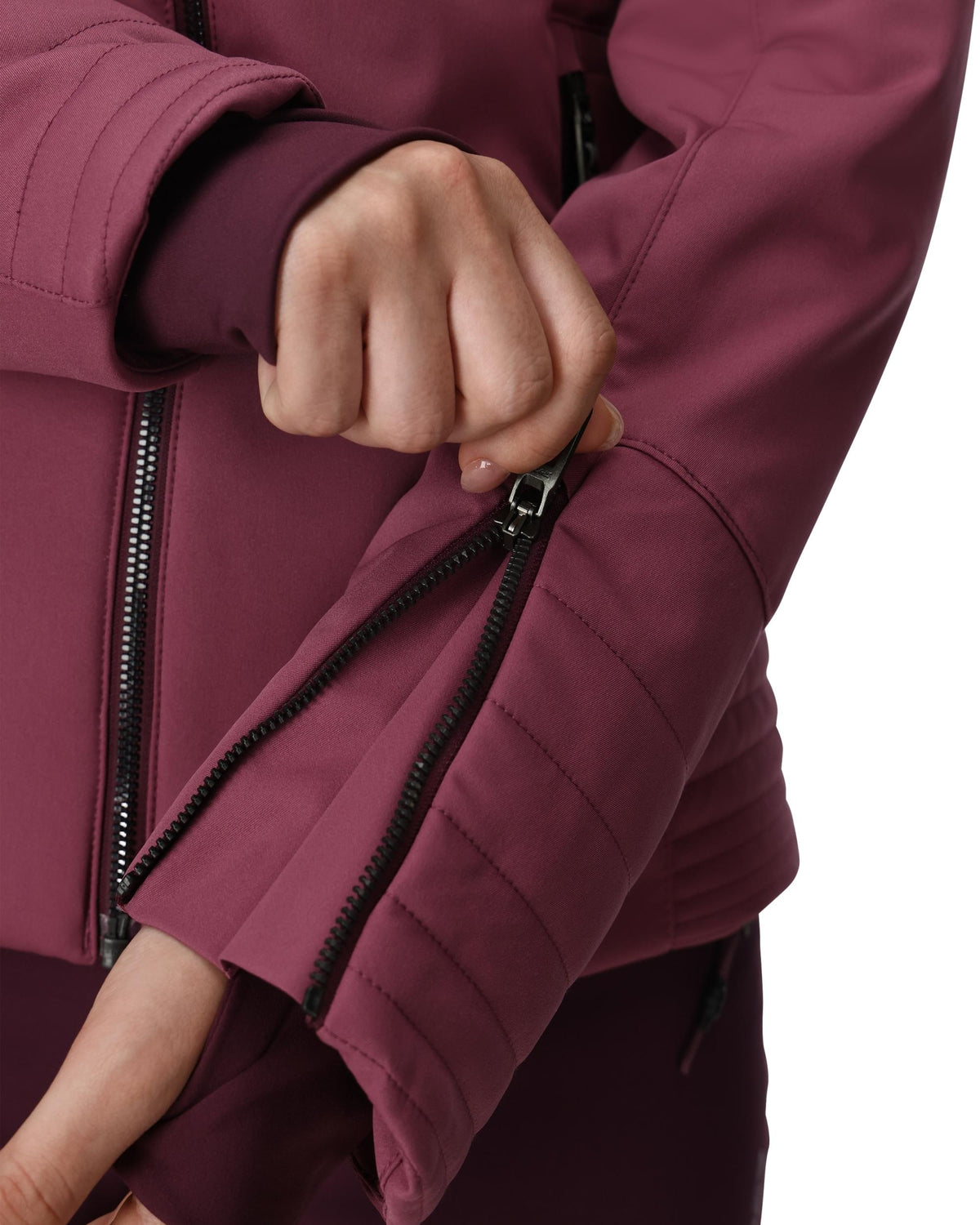 Close-up of a person wearing a maroon jacket with a focus on the zipper.