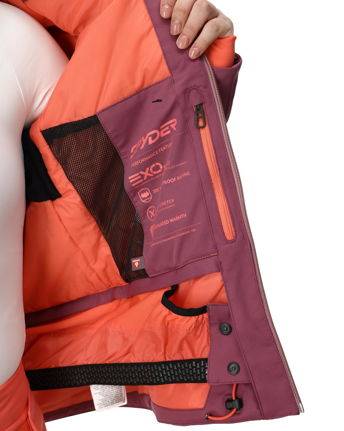 Close-up of a person wearing an orange and purple jacket with brand logo.