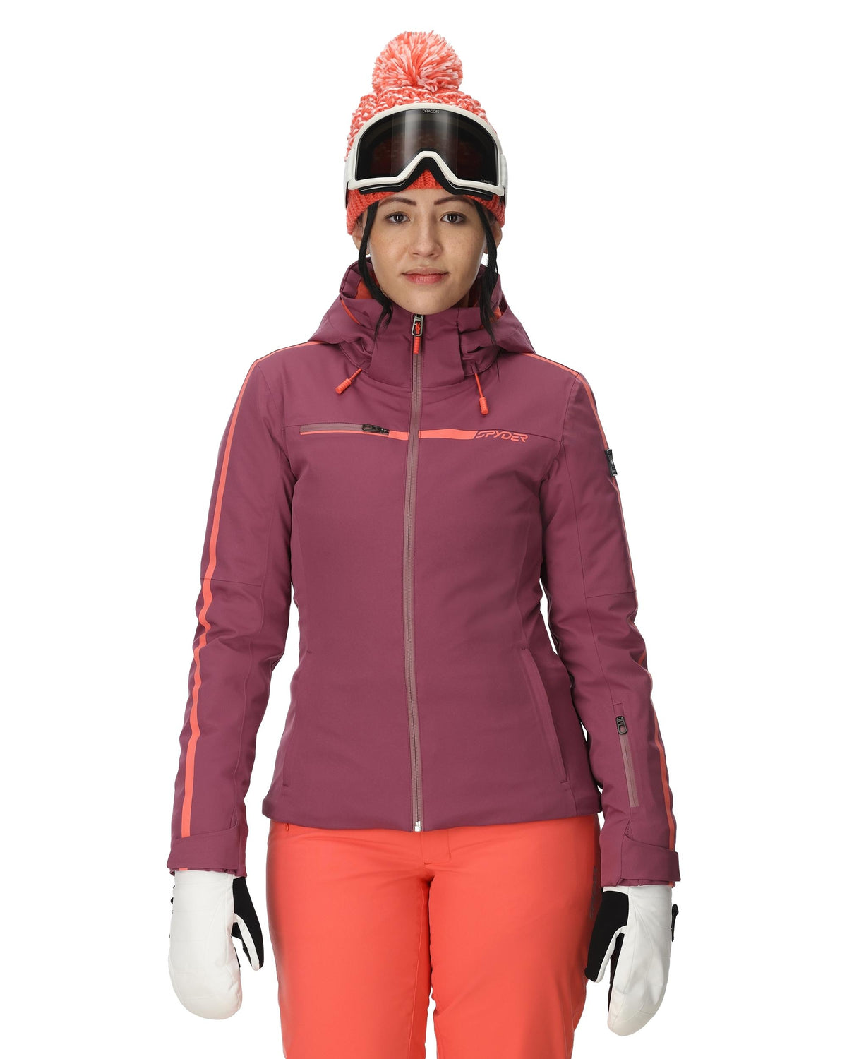 Person wearing a purple ski jacket, pink pants, and goggles on a white background