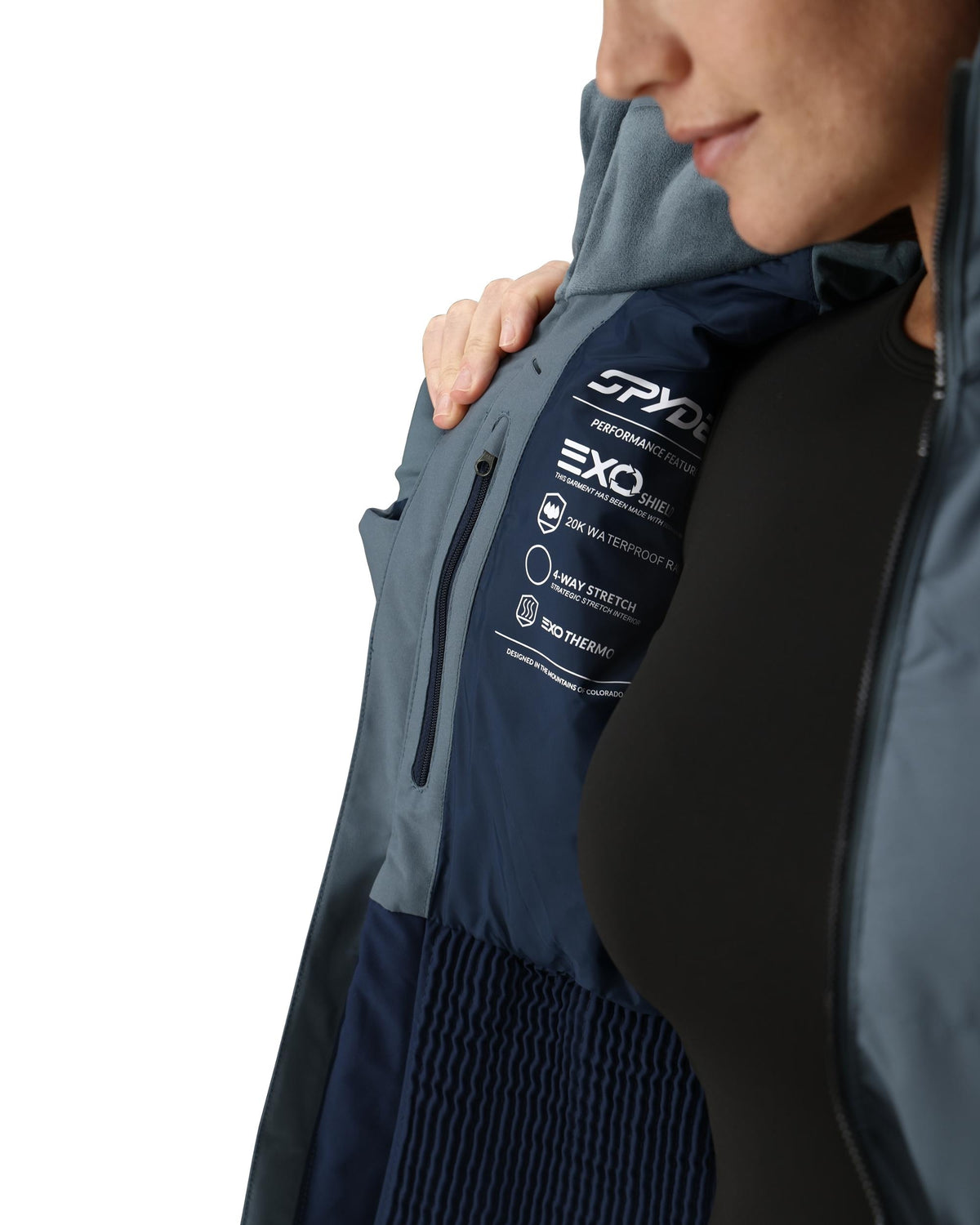 Person wearing a Spyder jacket with EXO technology on a white background