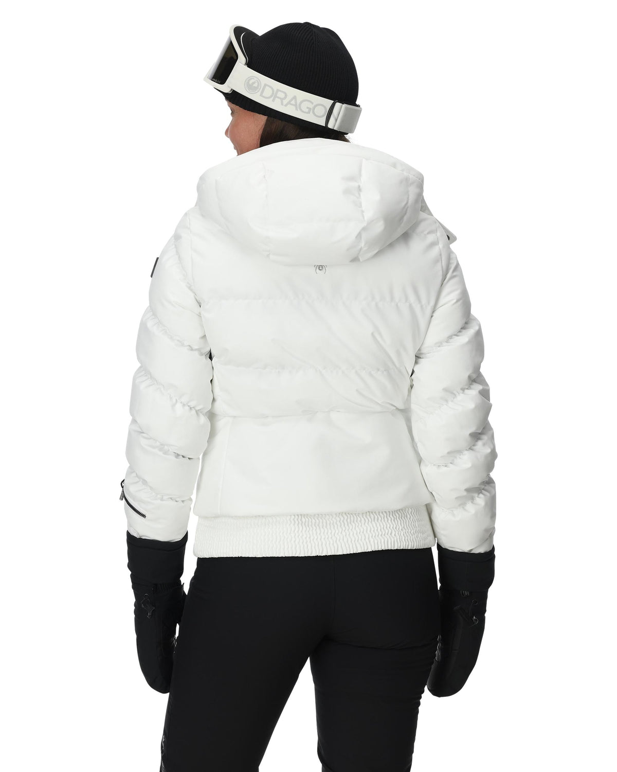 Person wearing a white puffer jacket, black pants, and gloves on a white background