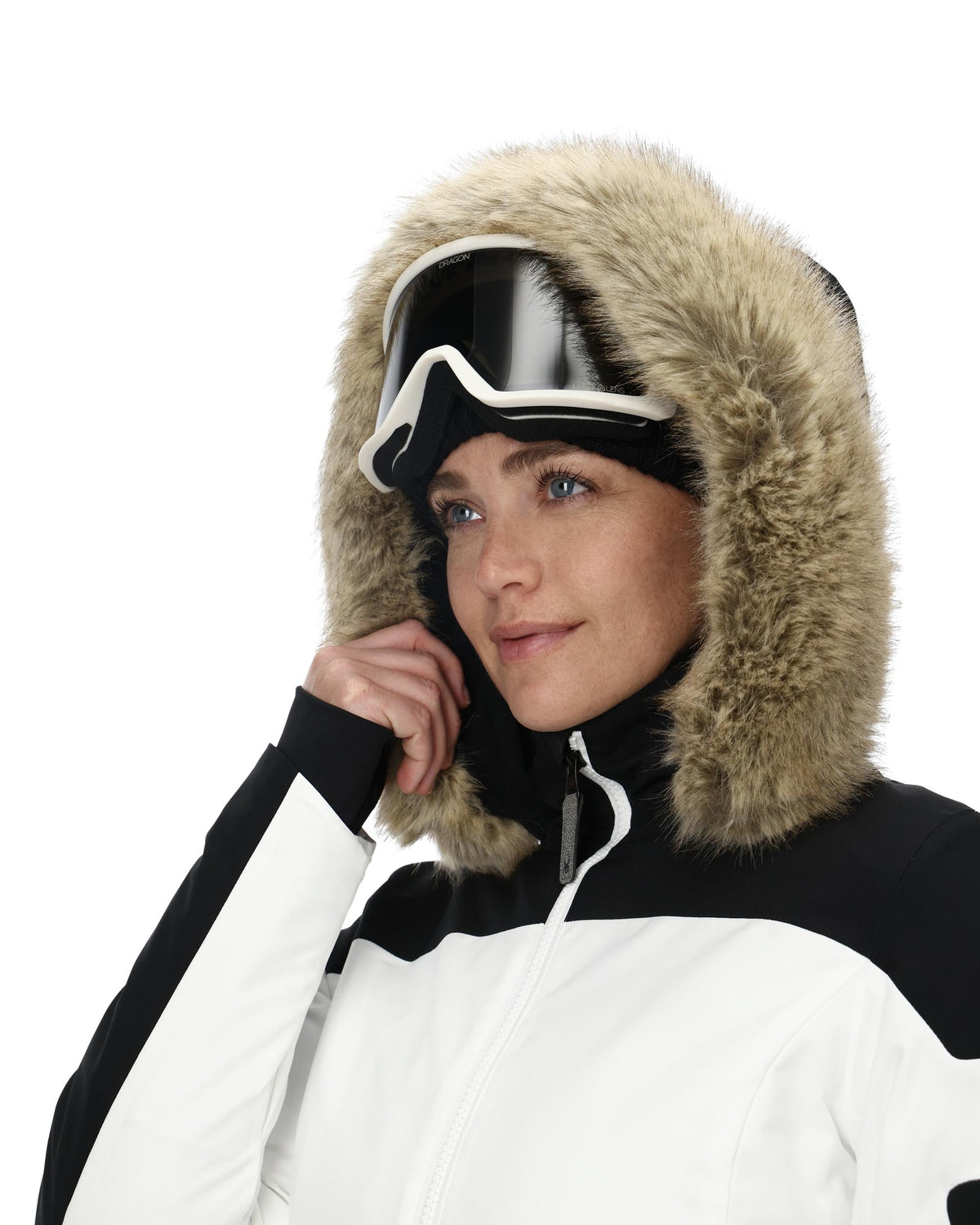 Person wearing a white and black winter coat with a fur-lined hood on a white background