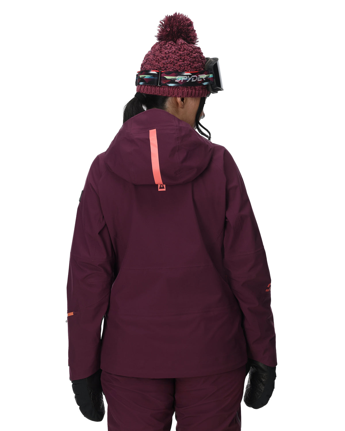 Person wearing a maroon snow jacket, pants, and hat on a white background