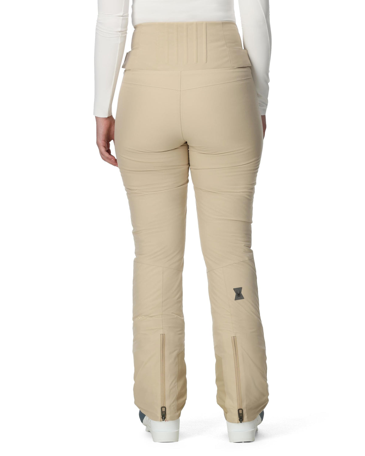 Beige ski pants worn by a person on a white background