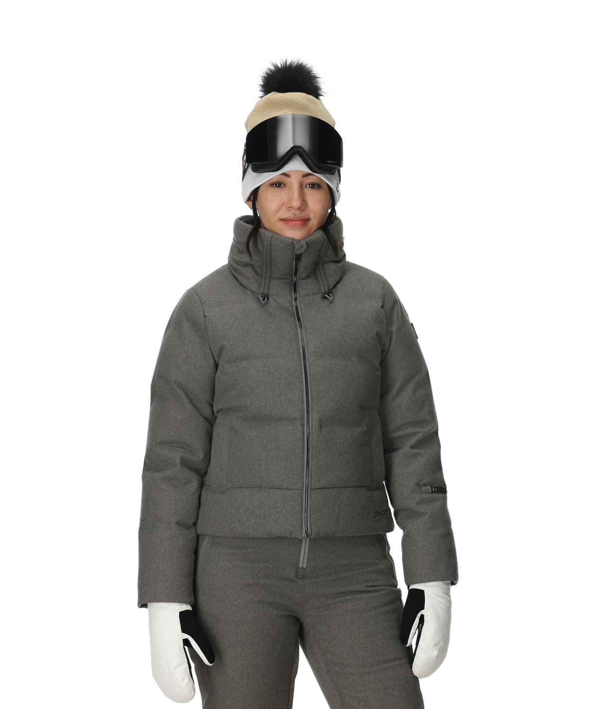 Person wearing a gray winter jacket, pants, gloves, and a beanie with goggles on a white background