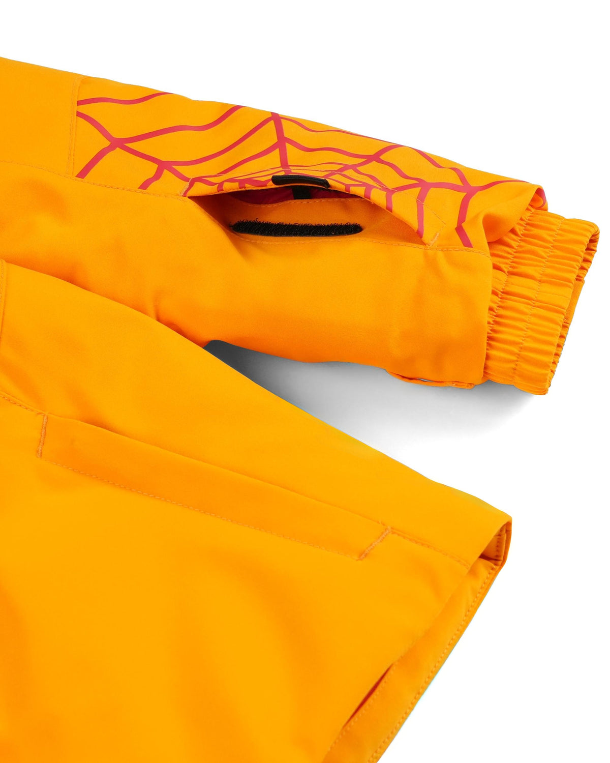 Orange pants with a spider web design on a white background