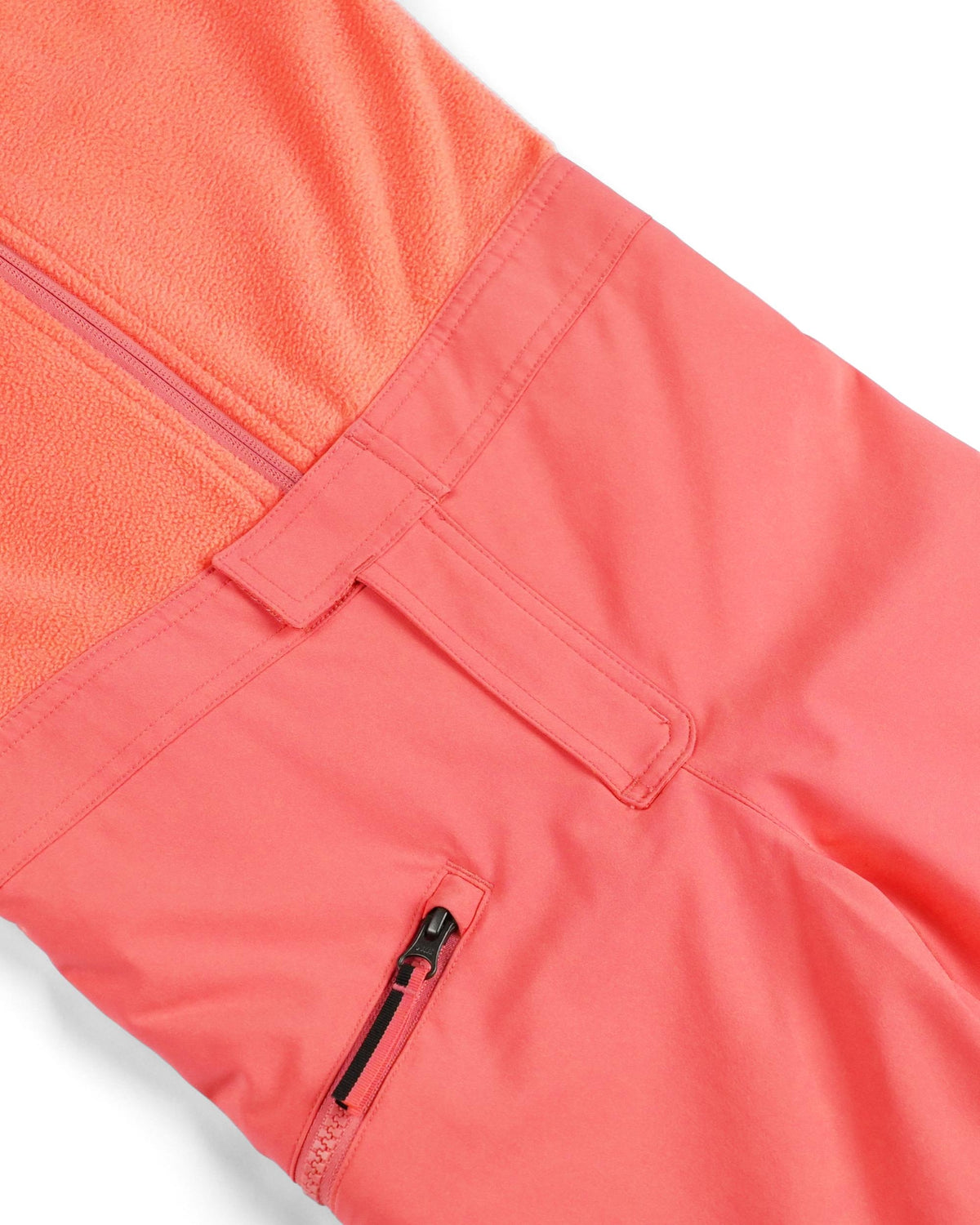 Close-up of a coral-colored jacket with a zipper pocket on a white background