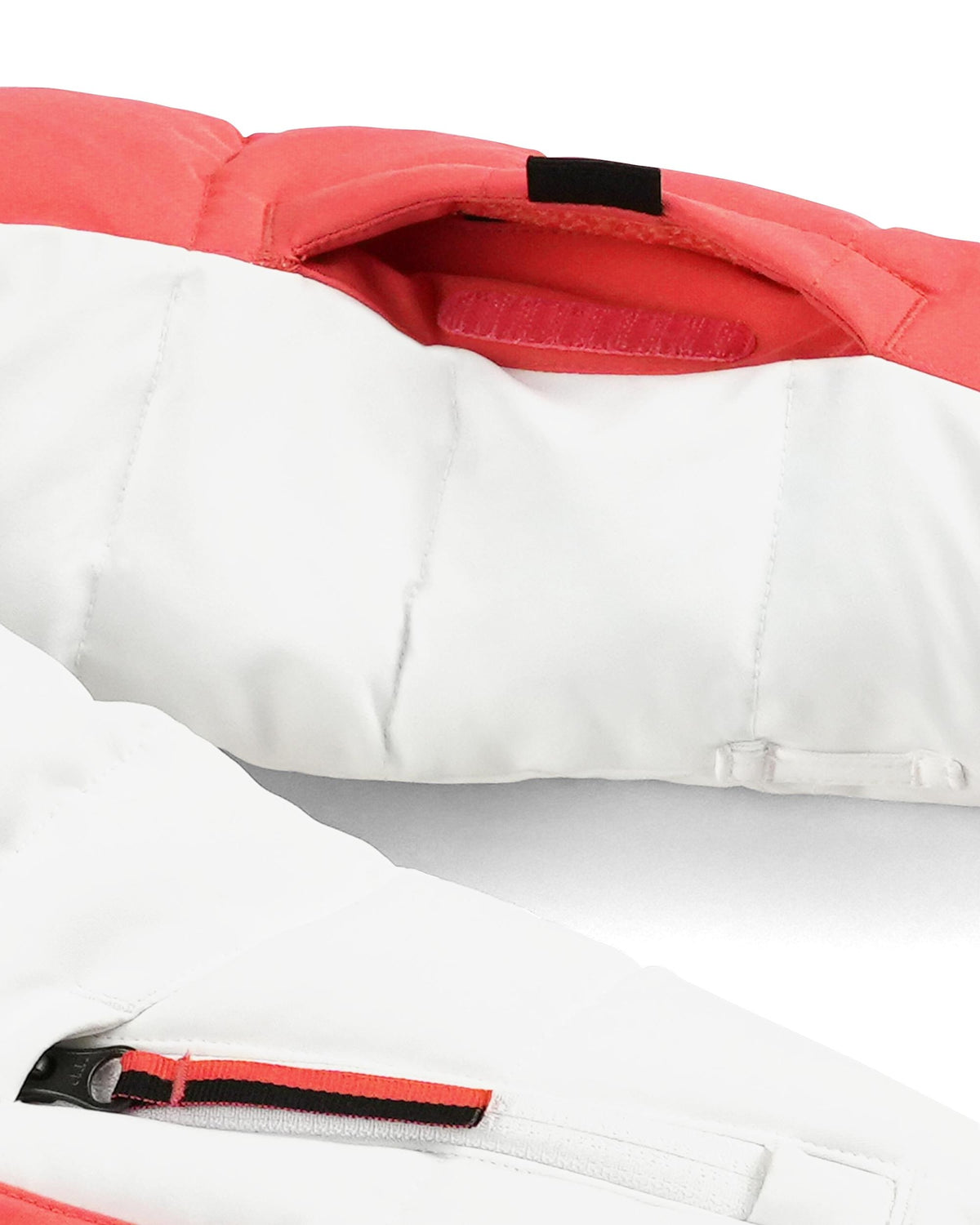 Close-up of a white and red jacket with a zipper detail.