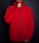 Red Spyder rain jacket with a brand logo on a black background