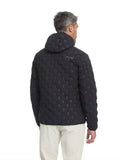 Man wearing a black quilted jacket with geometric pattern on a white background