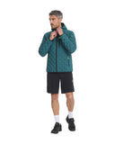 Man wearing a teal jacket with black shorts on a white background