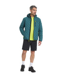Man wearing a teal quilted jacket with a hood, black shorts, and black shoes on a white background