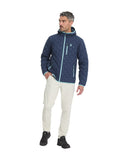 Man wearing a blue jacket with a logo, white pants, and black shoes on a white background