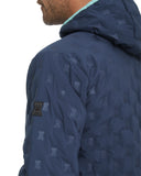 Navy blue patterned jacket with a brand logo on the sleeve against a white background