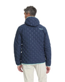 Person wearing a blue quilted jacket with a brand logo on the back, standing against a white background.