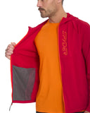 Person wearing a red jacket with a brand logo, orange shirt underneath, on a white background