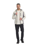 Man wearing a light gray jacket and black pants on a white background
