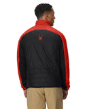 Person wearing a black and red jacket with a logo on the back, standing against a white background