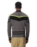 Man wearing a gray sweater with black and yellow stripes on a white background