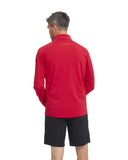 Person wearing a red long-sleeve shirt with a logo on the back, standing against a white background